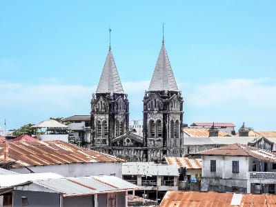 Twin spires of St. Joseph's Catholic Cathedral rising above the historic rooftops of Stone Town, Zanzibar.