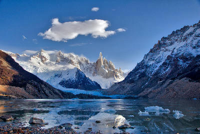 Laguna Torre with Cerro Torre and glacier reflected in calm water with floating ice, Patagonia, Argentina.