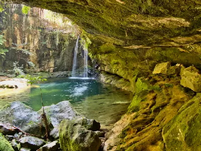 Waterfall and natural pool beneath sandstone overhang in Isalo National Park in Madagascar