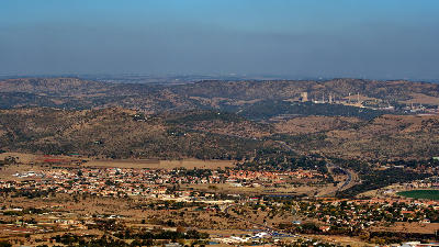 Elevated view across the Hartbeespoort valley and surrounding Magaliesberg foothills, seen from a mountain viewpoint above Hartbeespoort, South Africa.