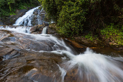 Water cascading over granite rock terraces at Debengeni Falls in the forests of Magoebaskloof, Limpopo, South Africa.