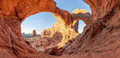 Double Arch sandstone formation framing desert landscape in Arches National Park Utah