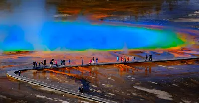 Grand Prismatic Spring Yellowstone National Park with boardwalk tourists and rising steam Wyoming USA
