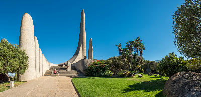 Wide view of the Afrikaans Language Monument near Paarl in the Western Cape, showing its sculptural concrete spires, landscaped gardens, and visitors ascending the monument steps.