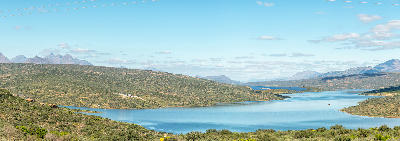 Panoramic landscape of Clanwilliam Dam surrounded by Cederberg foothills and mountain scenery in South Africa.