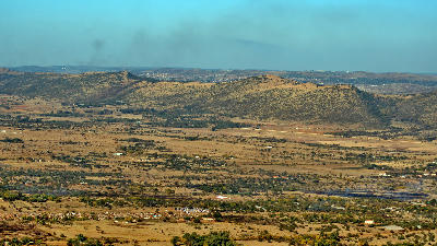 Wide view of the Magaliesberg foothills and dry valley landscapes near Hartbeespoort Dam in North West Province, South Africa.
