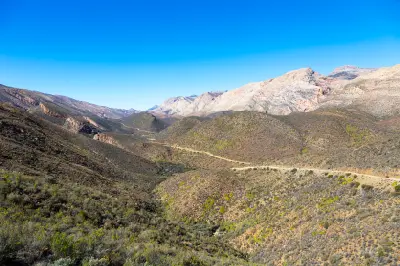 Mountain landscape with gravel roads leading toward Gamkaskloof through the Swartberg Mountains in the Klein Karoo, South Africa.