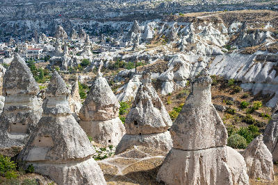 Fairy chimneys with rock-cut pigeon houses overlooking Göreme in Pigeon Valley, Cappadocia, Turkey.