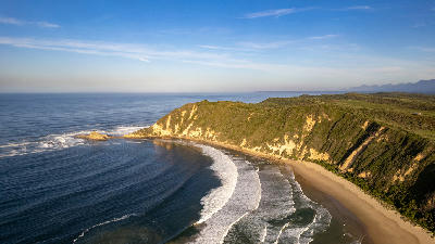 Aerial view of Gericke's Point showing fossilised dune cliffs, sandy coastline and ocean waves near Sedgefield on South Africa's Garden Route.