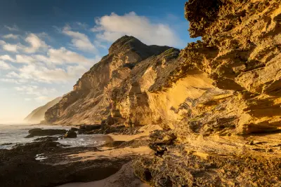 Golden-hour view of fossilised dune cliffs and weathered sandstone formations at Gericke's Point near Sedgefield on the Garden Route.