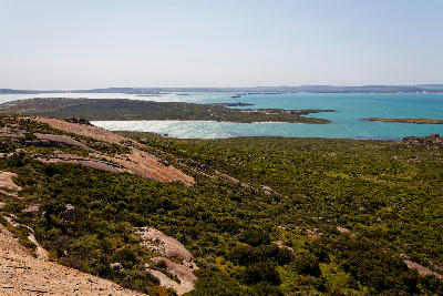 Granite slopes overlooking the islands and turquoise waters of Langebaan Lagoon from Seeberg Viewpoint in West Coast National Park, South Africa.