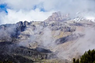 Clouds surrounding Kibo's southern cliffs above the Barranco Wall on Mount Kilimanjaro, Tanzania, at approximately 3,900 metres above sea level.