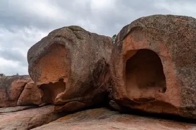 Close view of large pink granite boulders with deep weathered cavities at Sleepy Bay, Freycinet National Park, Tasmania.