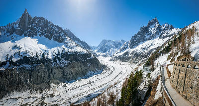 Mer de Glace valley glacier with surrounding alpine peaks and moraine bands in Chamonix, French Alps.