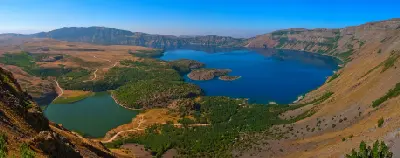 Panoramic view of deep blue Nemrut Crater Lake and smaller lakes within the volcanic caldera near Tatvan, eastern Turkey.