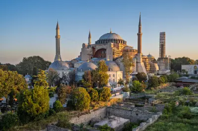 Elevated sunset view of Hagia Sophia in Istanbul showing its central dome, minarets and surrounding historic structures.