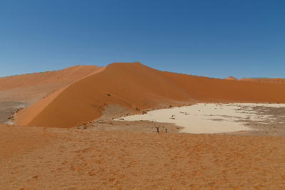 Orange sand dunes and the pale Hiddenvlei clay pan in the Sossusvlei area of Namibia’s Namib Desert.