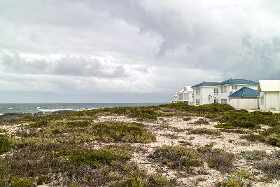 Granite shoreline, breaking Atlantic waves and coastal homes in Yzerfontein on South Africa's West Coast.
