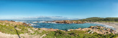 Panoramic view of Tietiesbaai near Paternoster showing granite outcrops, a sheltered sandy cove, coastal fynbos and Atlantic Ocean waves within Cape Columbine Nature Reserve.