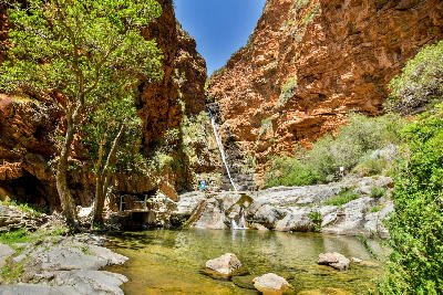Meiringspoort Waterfall and natural pool in the red sandstone cliffs of the Swartberg Mountains near De Rust in the Klein Karoo, South Africa.