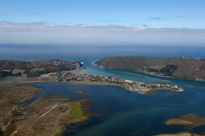 Aerial view of the Knysna Lagoon, wetlands and Knysna Heads on South Africa’s Garden Route, showing the estuary, coastline and surrounding forested hills.