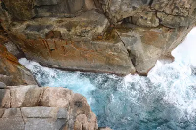 Turbulent seawater surging between the steep granite walls of The Gap in Torndirrup National Park near Albany, Western Australia.