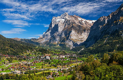Grindelwald village in a green alpine valley beneath the Eiger mountain, Switzerland.