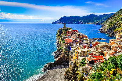 Scenic view of Vernazza, with colourful village buildings overlooking the ocean along the coast of Cinque Terre, Italy.
