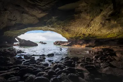 View from inside Waenhuiskrans Cave near Arniston looking through the large sea-cave opening toward the Indian Ocean, Western Cape, South Africa.