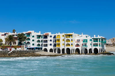 Mediterranean-style waterfront buildings at Club Mykonos overlooking the Atlantic coastline in Langebaan, South Africa.