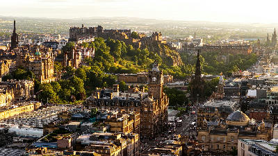 Aerial sunset view of Edinburgh showing Edinburgh Castle, the Balmoral Hotel clock tower and the Scott Monument.