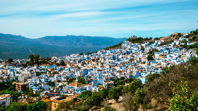 Panoramic view of Chefchaouen’s blue medina surrounded by the Rif Mountains in northern Morocco