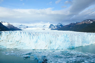 Upsala Glacier calving into Lago Argentino with floating icebergs and surrounding Andean peaks near El Calafate, Patagonia, Argentina.