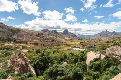 Panoramic landscape of Anja Community Reserve in Madagascar with granite mountain formations, agricultural valleys, and dry highland terrain