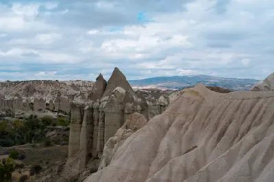Panoramic view of fairy chimneys and eroded volcanic ridges in Love Valley, Cappadocia, Turkey.