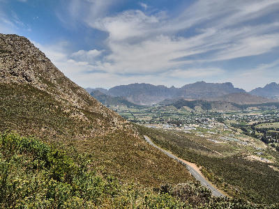 Panoramic view from Franschhoek Pass across the Franschhoek Valley and Cape Fold Mountains in the Western Cape of South Africa.
