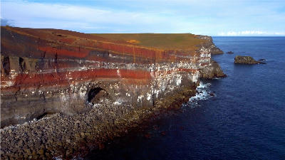 Layered coastal cliffs of Rauðaskriða at Krýsuvíkurberg on the Reykjanes Peninsula, Iceland, overlooking the North Atlantic Ocean.