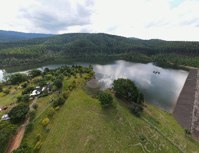 Aerial view of Magoebaskloof Dam bordered by forested hills and plantation forests in Limpopo, South Africa.