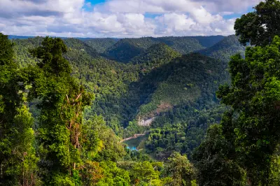 Elevated view of the North Johnstone River winding through forested valleys and mountains in the Atherton Tablelands, Queensland.