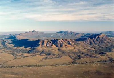 Aerial view of Wilpena Pound's sweeping mountain ridges and sandstone escarpments in the Flinders Ranges, South Australia.