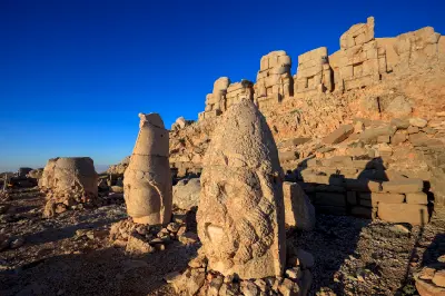 Fallen stone heads before colossal seated statues on Mount Nemrut’s East Terrace.
