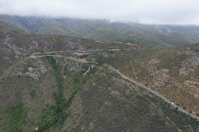 A winding section of Franschhoek Pass crossing rugged mountain slopes beneath low cloud in the Cape Winelands of South Africa.