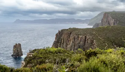 Columnar dolerite cliffs, sea stack and coastal walking track at Cape Hauy, Tasmania.