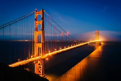 Golden Gate Bridge at night from Battery Spencer with light trails fading into fog