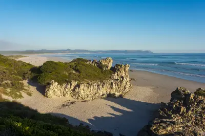 View from the Hermanus Cliff Path over Grotto Beach and Walker Bay toward the distant coastline of Gansbaai in South Africa
