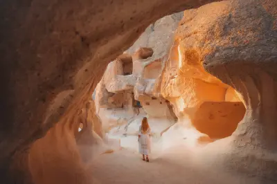 Pasabag (Monks Valley) in Cappadocia, Turkey, showing tall fairy chimneys and cave dwellings lit by low golden light.