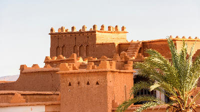 Traditional adobe architecture and rooftop fortifications at Kasbah Taourirt in Ouarzazate, Morocco.