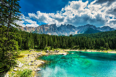 Turquoise Lago di Carezza lake with the Latemar mountains in the Dolomites near Bolzano, Italy.