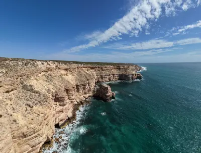 Wide aerial view of Island Rock beneath the layered coastal cliffs of Kalbarri National Park.