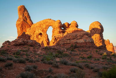 Turret Arch sandstone formation with desert terrain in Arches National Park Utah